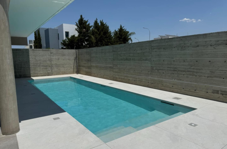 Modern outdoor swimming pool with concrete walls